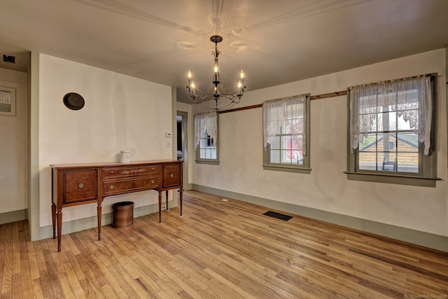 dining room featuring light hardwood / wood-style floors and a notable chandelier