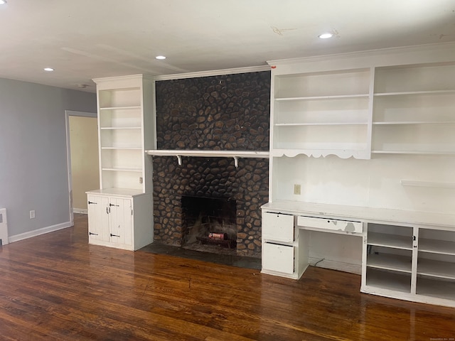 unfurnished living room with dark hardwood / wood-style flooring and a fireplace