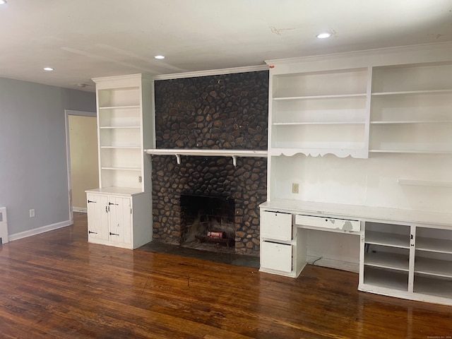 unfurnished living room featuring a fireplace and dark hardwood / wood-style floors