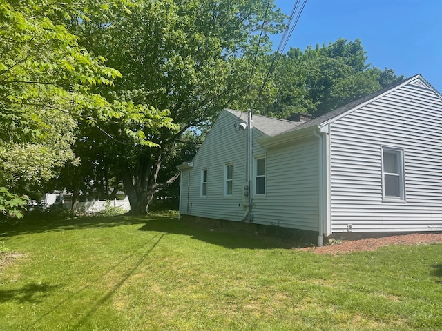 view of side of home featuring a lawn