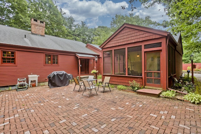 view of patio / terrace with area for grilling and a sunroom