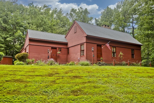 back of property featuring a yard