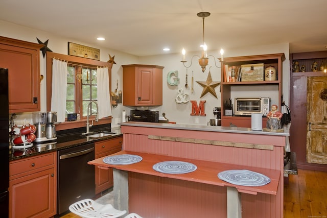 kitchen featuring hardwood / wood-style floors, sink, hanging light fixtures, dishwashing machine, and a chandelier