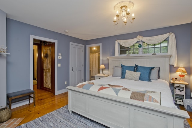 bedroom featuring a chandelier and wood-type flooring