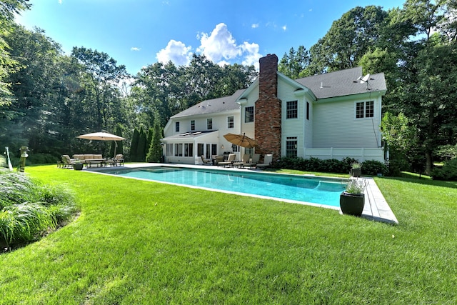 rear view of house with a yard and a patio