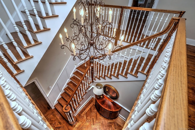 stairs featuring a chandelier