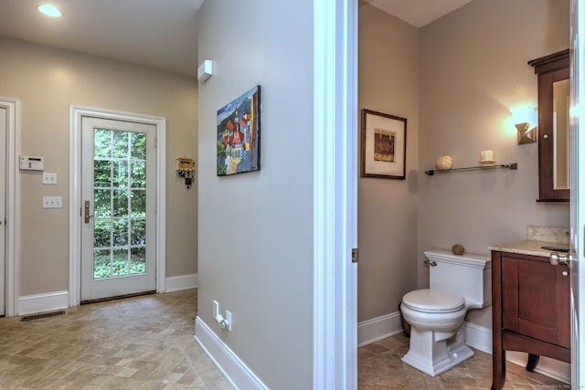 bathroom featuring toilet and vanity