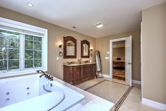 bathroom featuring vanity, tile patterned flooring, and a bathing tub