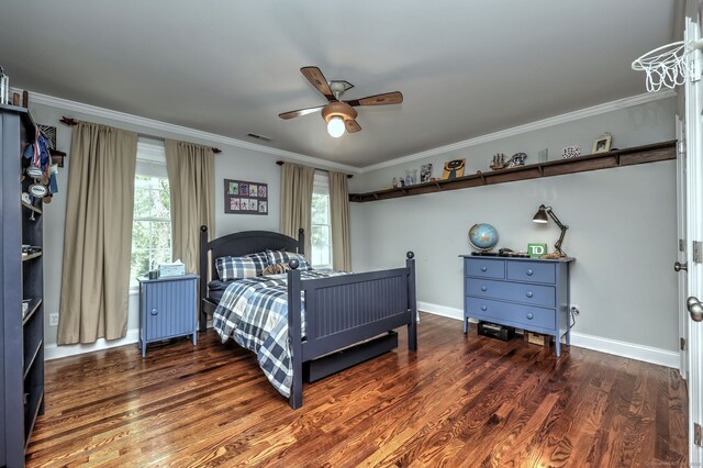 bedroom featuring dark hardwood / wood-style flooring, ornamental molding, and ceiling fan