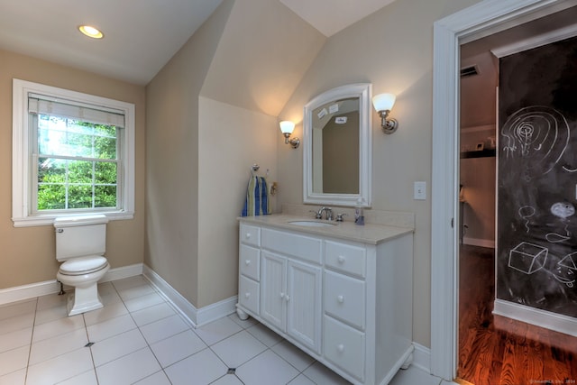 bathroom with vanity, toilet, tile patterned floors, and vaulted ceiling