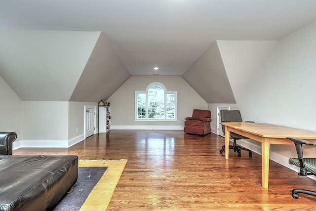 home office featuring hardwood / wood-style floors and vaulted ceiling