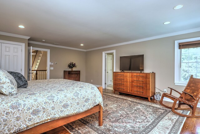 bedroom with crown molding and wood-type flooring