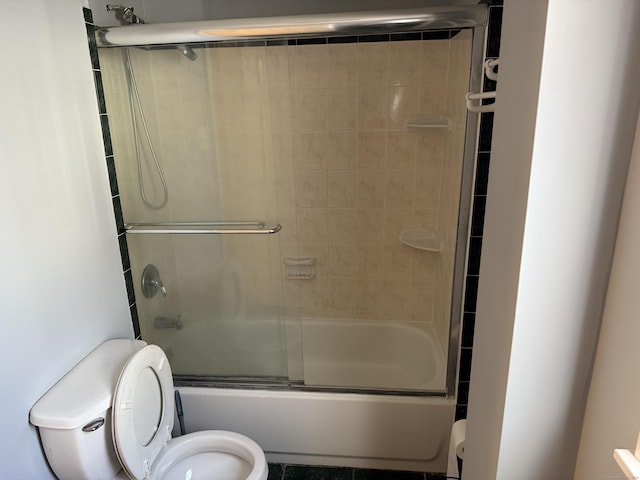 bathroom with toilet and enclosed tub / shower combo