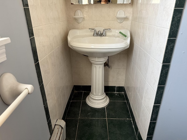 bathroom featuring tile patterned flooring, decorative backsplash, and tile walls