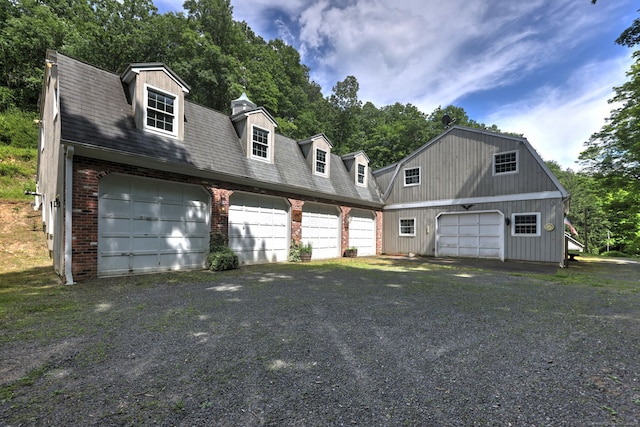 cape cod-style house featuring a garage