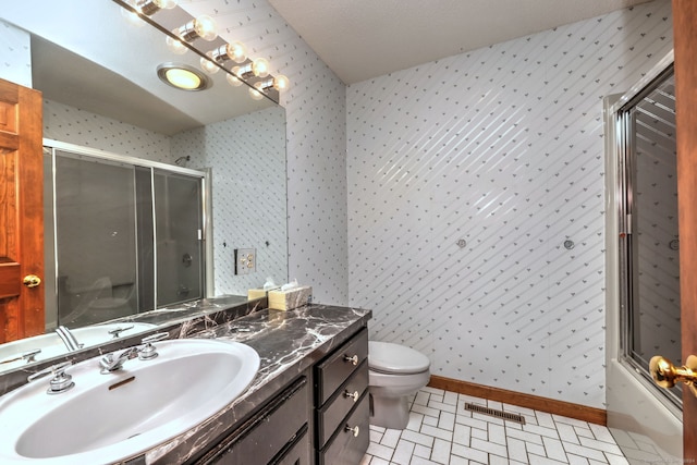 full bathroom with tile patterned floors, vanity, toilet, and bath / shower combo with glass door