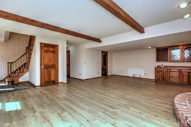 unfurnished living room featuring light hardwood / wood-style floors and bar