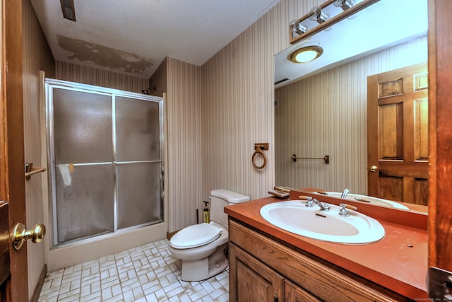 bathroom featuring vanity, toilet, and walk in shower