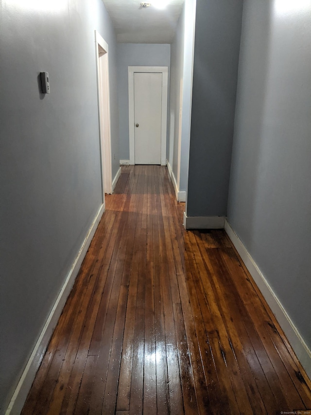 corridor featuring dark hardwood / wood-style floors