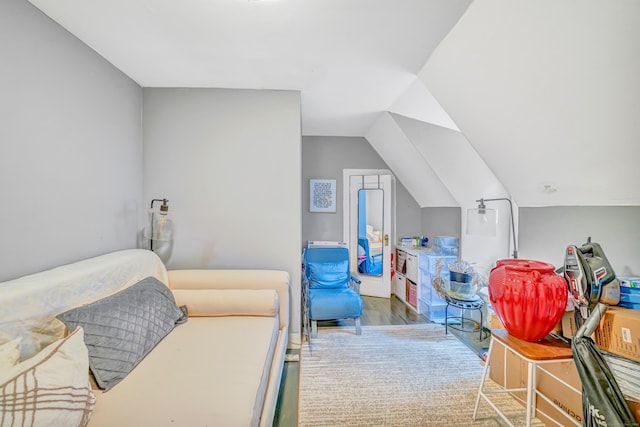 bedroom featuring hardwood / wood-style floors and vaulted ceiling