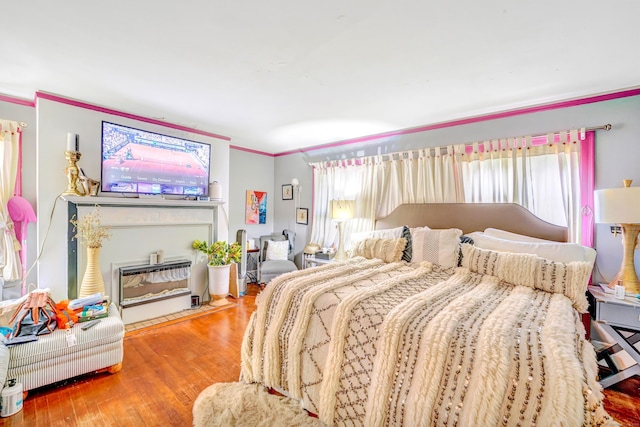 bedroom with hardwood / wood-style flooring and ornamental molding