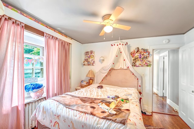 bedroom with ceiling fan and hardwood / wood-style flooring