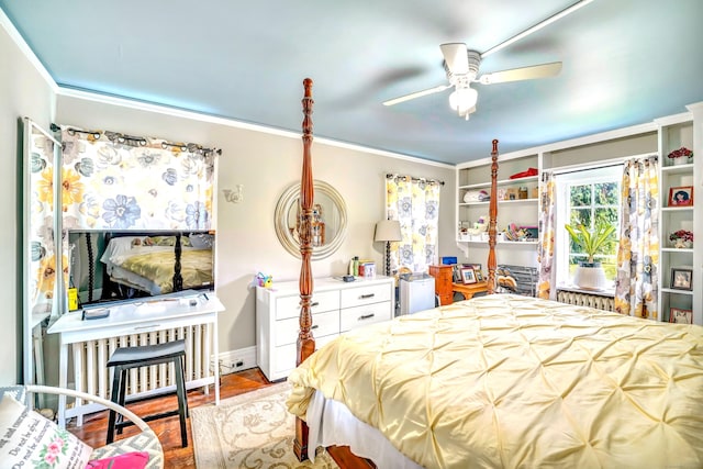 bedroom featuring ceiling fan, hardwood / wood-style floors, and ornamental molding