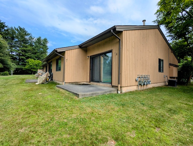 rear view of house with a lawn, a patio, and central air condition unit