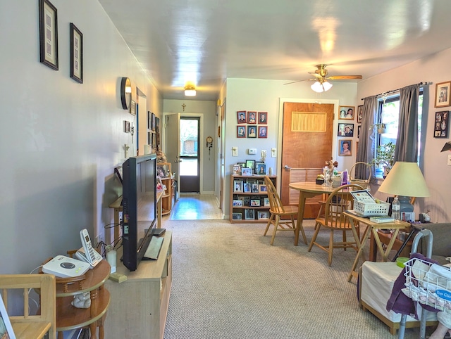 carpeted living room with ceiling fan