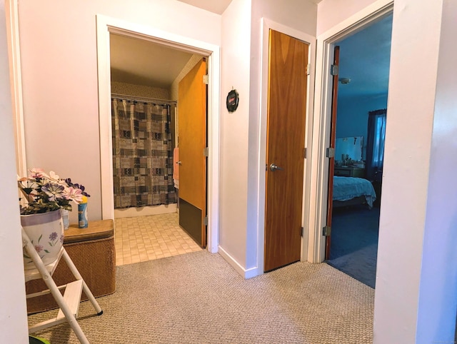 hallway featuring light carpet