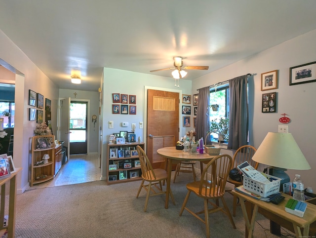 carpeted dining area featuring ceiling fan