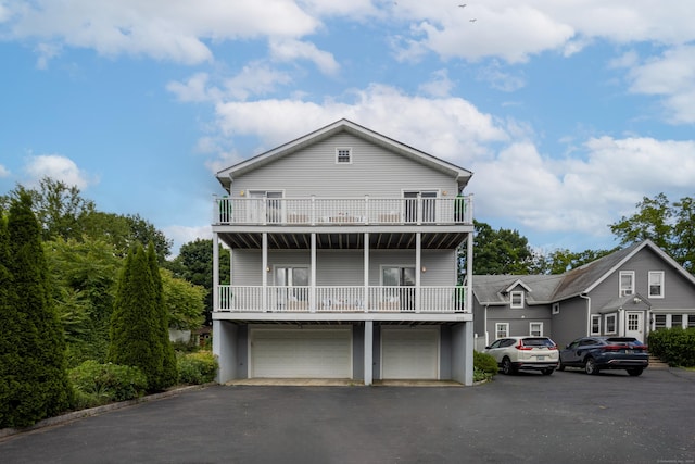 view of front facade featuring a garage and a balcony