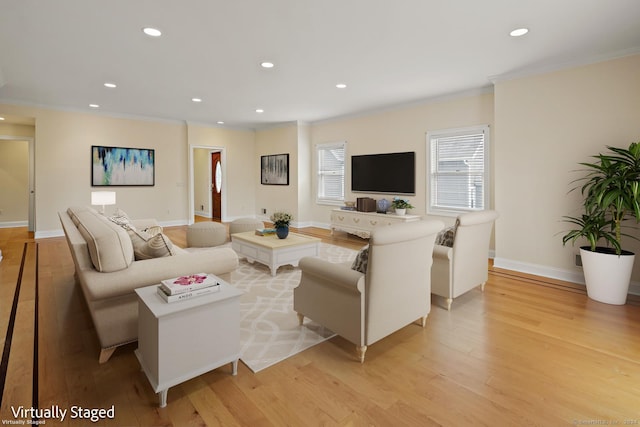 living room featuring crown molding and light hardwood / wood-style floors