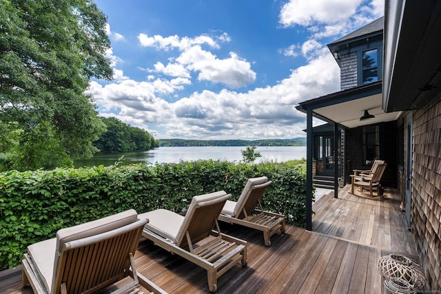 wooden terrace featuring a water view