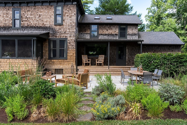 back of property with outdoor lounge area and a patio