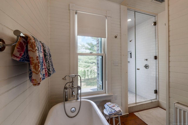 bathroom with radiator heating unit and a bathtub