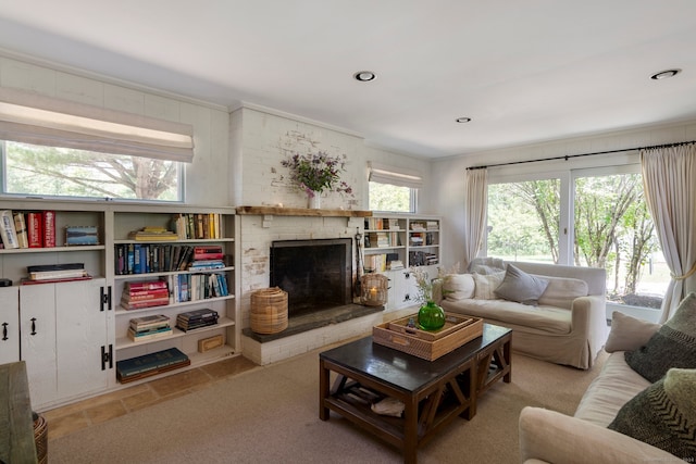 carpeted living room with a brick fireplace