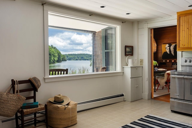 sitting room with baseboard heating and a water view