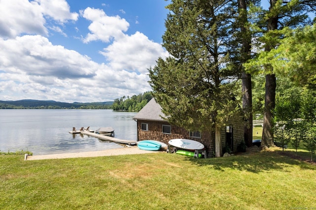 dock area featuring a lawn and a water view