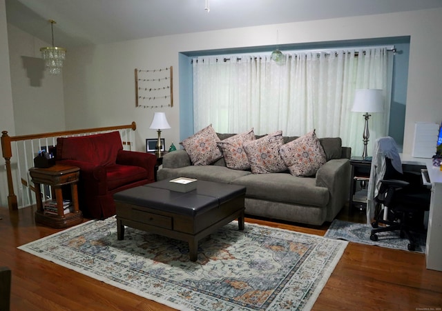 living room with hardwood / wood-style floors and a chandelier