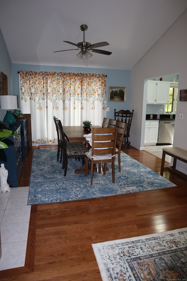 dining area with light hardwood / wood-style flooring, lofted ceiling, and ceiling fan