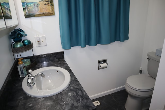 bathroom featuring sink, tile patterned flooring, and toilet