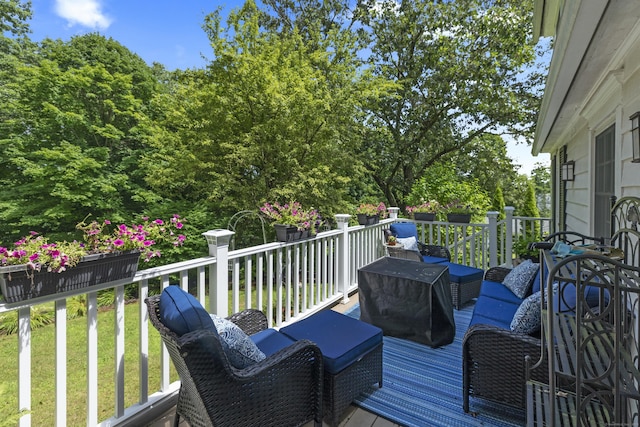 wooden terrace with a lawn