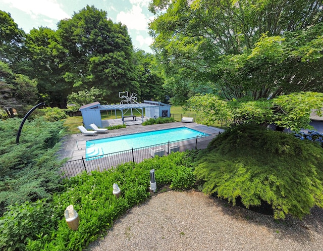 view of pool featuring an outbuilding and a patio