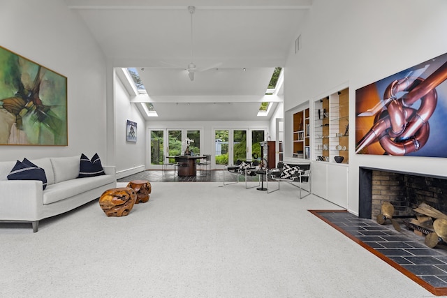 living room with vaulted ceiling with skylight and carpet flooring