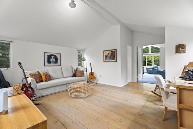 living room with beamed ceiling, wood-type flooring, and high vaulted ceiling