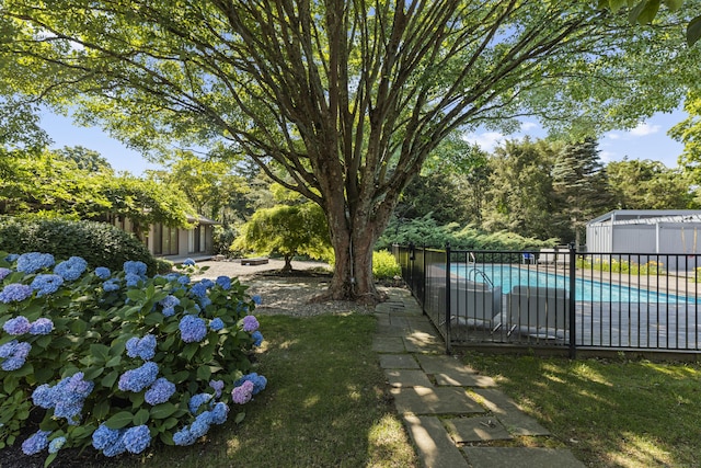 view of yard with a fenced in pool