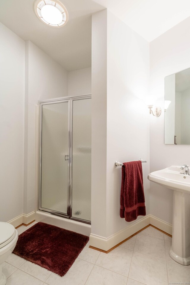 bathroom with tile patterned floors, sink, toilet, and walk in shower