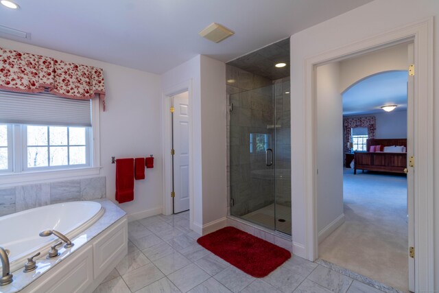 bathroom featuring separate shower and tub