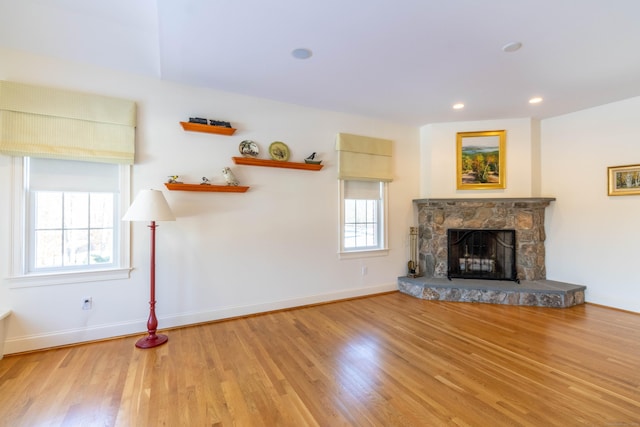 unfurnished living room featuring a fireplace and hardwood / wood-style flooring